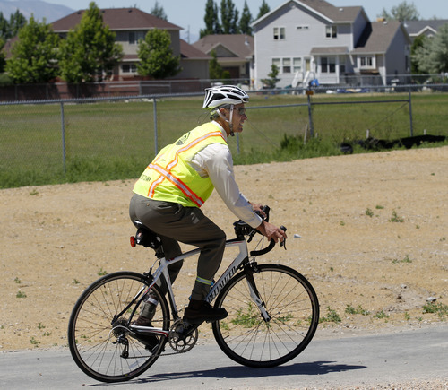 Al Hartmann  |  The Salt Lake Tribune 
Salt Lake City Mayor Ralph Becker rides his bike on the newly  completed section of the Jordan River Parkway Trail at 1800 North Redwood Road on Thursday.