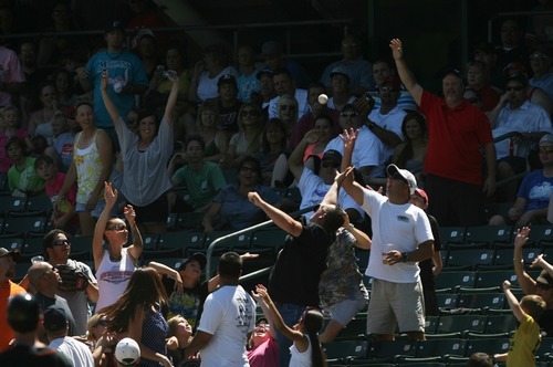Kim Raff | The Salt Lake Tribune
Fans catch a ball thrown into the stands during a Salt Lake Bees game against the Fresno Grizzlies at Spring Mobile Ballpark in Salt Lake City on June 17, 2012.
