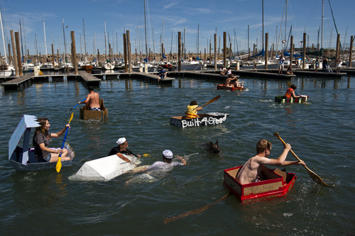 Chris Detrick  |  The Salt Lake Tribune
Jake Hansen and Sam Paniagua capsize their boat 'White Rhino' as other racers compete in a cardboard boat race during The Great Salt Lake Yacht Club's SailFest Saturday June 16, 2012.  SailFest is an annual event hosted by the club, established in 1877.