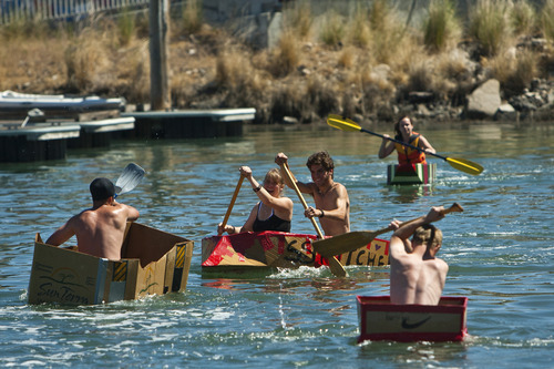 Chris Detrick  |  The Salt Lake Tribune
Saige and Kaio Alloway, of Tooele, center, compete in a cardboard boat race during The Great Salt Lake Yacht Club's SailFest Saturday June 16, 2012.  SailFest is an annual event hosted by the club, established in 1877.