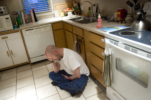 Kim Raff | The Salt Lake Tribune
Dov Siporin sits on the kitchen floor in pain. Siporin has terminal colon cancer. 