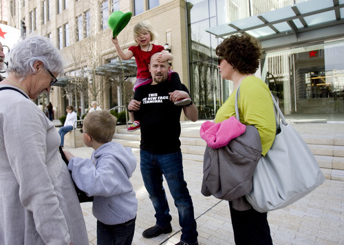Kim Raff | The Salt Lake Tribune
Holding his daughter, Siena Siporin, and surrounded by his family, Dov Siporin stands outside of the City Creek Center in Salt Lake City after participating in a flash mob. Siporin has terminal colon cancer and is well-known for silly antics, trying to put an uplifting spin to his disease. He believes having a positive outlook helps to distract him from the pain he is feeling.