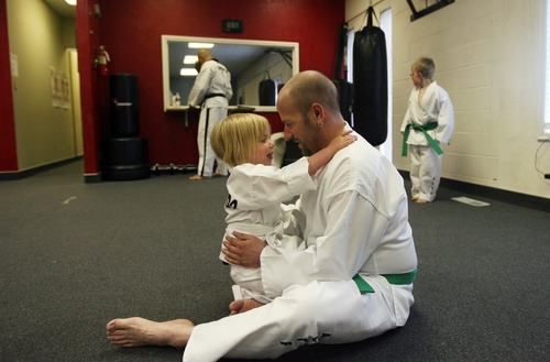 Kim Raff | The Salt Lake Tribune
Dov Siporin hugs his daughter, Siena, while warming up for a lesson at Salt Lake Valley Tae Kwon Do Academy in Salt Lake City. Dov takes lessons with his kids when he is feeling well enough.