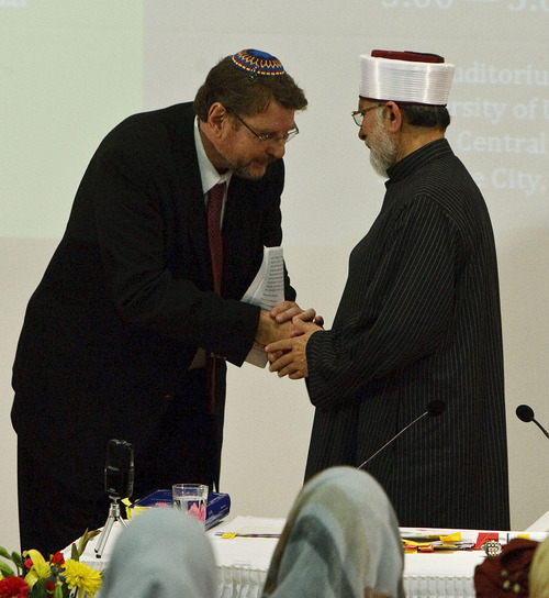 Leah Hogsten  |  The Salt Lake Tribune
Alan Bachman, chairman of the Salt Lake Interfaith Roundtable welcomes Dr. Muhammad Tahir ul Qadri (right). Muslim scholar Dr. Muhammad Tahir ul Qadri, a Pakistani cleric who issued a 2010 fatwa condemning terrorism and suicide bombings as contrary to Islamic law delivers his lecture 