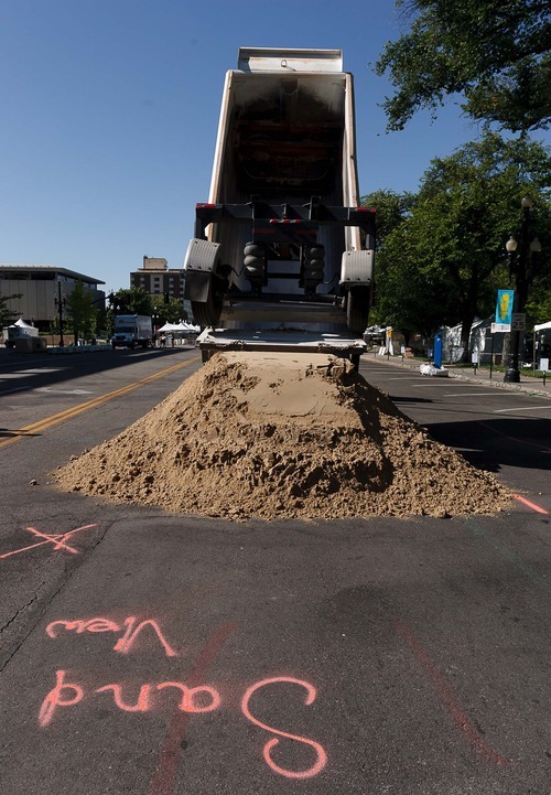 Trent Nelson  |  The Salt Lake Tribune
Twenty tons of sand are dumped on June 19, 2012 for a sand sculpture being created by artist Ted Siebert as part of the Utah Arts Festival in Salt Lake City.