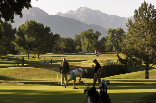 Al Hartmann  |  The Salt Lake Tribune 
A trio of golfers finish up on the ninth hole during an early morning round on a cool morning Tuesday, June 19 at Forrest Dale Golf Course  in Salt Lake City.