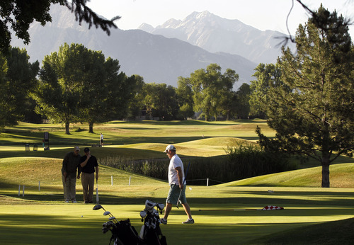 Al Hartmann  |  The Salt Lake Tribune 
Trio of golfers finish up on the ninth hole during an early morning round on a perfect cool morning Tuesday June 19 at Forrest Dale Golf Course  in Sugarhouse.