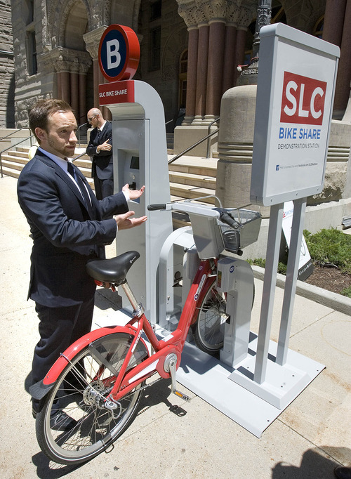 Paul Fraughton | The Salt Lake Tribune
Ben Bolte, bike share project manager, demonstrates how to use a bike-share station on Tuesday, June 19, 2012. The Salt Lake City program expects to kick into gear in March 2013.