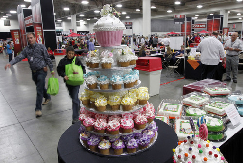 Al Hartmann  |  The Salt Lake Tribune
Folks pass by cupcake display of CSM Bakery Products at the Associated Food Stores Food Show 2012 at the Salt Palace Convention Center Wednesday June 20.  CSM is a national chain but has a faciloity in Pleasant View, UT.   The food show includes Utah grown and manufactured products to be seen by  400 grocers doing business in eight states.