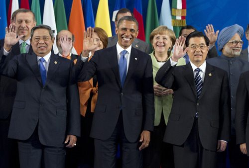 President Barack Obama takes his place with other leaders for the Family Photo during the G20 Summit, Monday, June 18, 2012, in Los Cabos, Mexico. From left, Indonesian President Susilo Bambang Yudhoyono, U.S. President Barack Obama, German Chancellor Angela Merkel, Chinese President Hu Jintao, Indian Prime Minister Manmohan Singh. (AP Photo/Carolyn Kaster)
