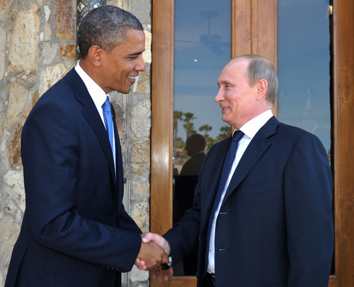 U.S. President Barack Obama, left, greets Russia's President Vladimir Putin at the G-20 Summit in Los Cabos, Mexico, Monday, June 18, 2012. President Barack Obama and Russian President Vladimir Putin huddle on the sidelines of the G-20 meeting in Mexico, in what officials say will be a candid, get-down-to-business meeting about their mutual interests and disagreements. It's their first meeting since Putin returned to Russia's top job.  (AP Photo/RIA-Novosti, Alexei Nikolsky, Presidential Press Service)