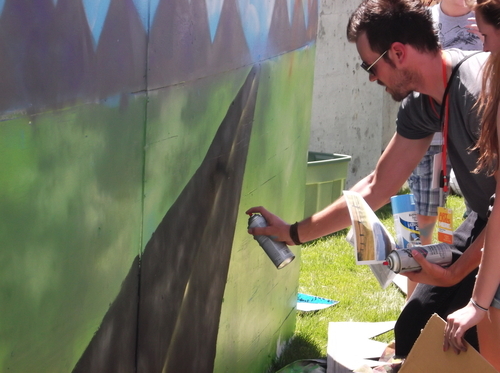 Students from Higher Ground Learning add to the Open Road Project Mural, Thursday at the Urban Arts area of the Utah Arts Festival. (photo by Sean P. Means  |  The Salt Lake Tribune)