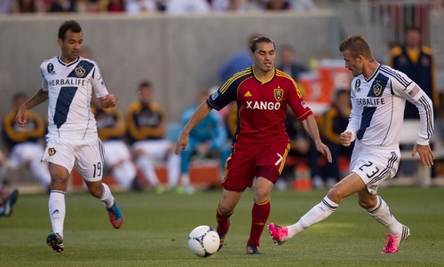 Trent Nelson  |  The Salt Lake Tribune
David Beckham kicks the ball, with RSL's Fabian Espindola, center, and L.A.'s Juninho at left, as Real Salt Lake hosts the L.A. Galaxy at Rio Tinto Stadium on Wednesday, June 20, 2012, in Sandy.