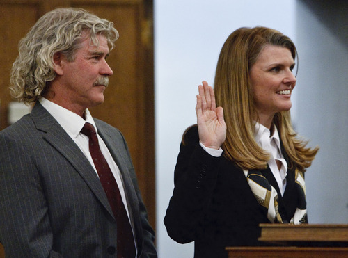 Leah Hogsten  |  The Salt Lake Tribune
Evelyn J. Furse (right) takes the oath of office as U.S. Magistrate Judge next to her husband Rusty Dassing. Evelyn J. Furse became the newest magistrate judge for the U.S. District Court for Utah Friday, June 22, 2012 in Salt Lake City. Furse was a senior attorney for Salt Lake City Corp., where among other things she defended the city's proposed soccer complex bond, before being nominated to fill the position vacated by new federal Judge David Nuffer. Before joining the city, Furse clerked for Utah Supreme Court Justice Christine Durham and then worked for several local law firms. She is a past president of the Women Lawyers of Utah and chaired its Initiative on the Advancement and Retention of Women Attorneys. Furse graduated with a bachelor's degree in public policy analysis from the University of North Carolina in 1993. She attended law school at New York University School of Law in 1996. Magistrate judges conduct preliminary hearings in criminal cases and also handle other criminal and civil matters as assigned by district judges.