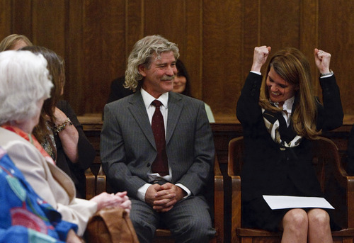 Leah Hogsten  |  The Salt Lake Tribune
Evelyn J. Furse (right) raises her fists in celebration to the amusement of her husband Rusty Dassing and others at her swearing-in ceremony after fellow colleague Edwin P. Rutan, II told her she was the Salt Lake City Attorneys offices' 