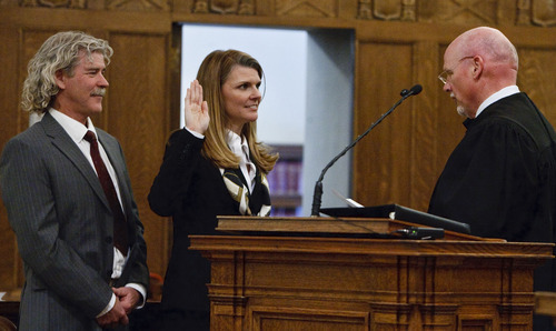 Leah Hogsten  |  The Salt Lake Tribune
Evelyn J. Furse (right) takes the oath of office as U.S. Magistrate Judge next to her husband Rusty Dassing before Chief Judge Ted Stewart (right). Evelyn J. Furse became the newest magistrate judge for the U.S. District Court for Utah Friday, June 22, 2012 in Salt Lake City. Furse was a senior attorney for Salt Lake City Corp., where among other things she defended the city's proposed soccer complex bond, before being nominated to fill the position vacated by new federal Judge David Nuffer. Before joining the city, Furse clerked for Utah Supreme Court Justice Christine Durham and then worked for several local law firms. She is a past president of the Women Lawyers of Utah and chaired its Initiative on the Advancement and Retention of Women Attorneys. Furse graduated with a bachelor's degree in public policy analysis from the University of North Carolina in 1993. She attended law school at New York University School of Law in 1996. Magistrate judges conduct preliminary hearings in criminal cases and also handle other criminal and civil matters as assigned by district judges.