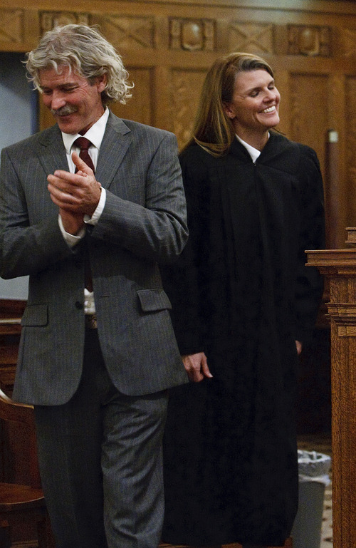 Leah Hogsten  |  The Salt Lake Tribune
Evelyn J. Furse stands as a newly robed U.S. Magistrate Judge next to her husband Rusty Dassing after swearing the oath of office. Evelyn J. Furse became the newest magistrate judge for the U.S. District Court for Utah Friday, June 22, 2012 in Salt Lake City. Furse was a senior attorney for Salt Lake City Corp., where among other things she defended the city's proposed soccer complex bond, before being nominated to fill the position vacated by new federal Judge David Nuffer. Before joining the city, Furse clerked for Utah Supreme Court Justice Christine Durham and then worked for several local law firms. She is a past president of the Women Lawyers of Utah and chaired its Initiative on the Advancement and Retention of Women Attorneys. Furse graduated with a bachelor's degree in public policy analysis from the University of North Carolina in 1993. She attended law school at New York University School of Law in 1996. Magistrate judges conduct preliminary hearings in criminal cases and also handle other criminal and civil matters as assigned by district judges.