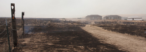 Christopher Reeves  |  Special to The Salt Lake Tribune

Fence posts continue to burn in the scorched ground near homes in Saratoga Springs on Friday, June 22, 2012.