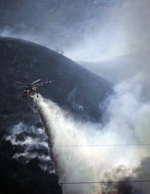 Kim Raff |  The Salt Lake Tribune
Helicopters are used on the Dump Fire in Saratoga Springs-Eagle Mountain area in Saratoga Springs, Utah on June 22, 2012.