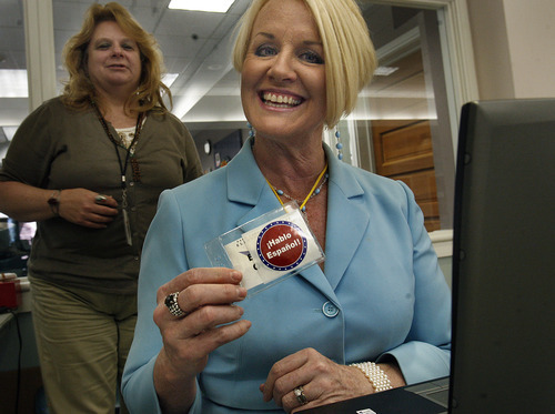Scott Sommerdorf  |  The Salt Lake Tribune             
Election Judge Blythe Carlsen proudly shows off her badge that tells voters of her language skills at the Eddie P. Mayne Kearns Senior Center in Kearns. The Salt Lake County Clerk's Office has had to add election judges, especially Spanish-speaking judges, to be fully staffed for Tuesday's primary.