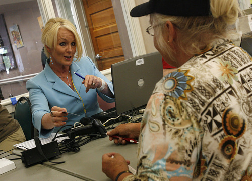 Scott Sommerdorf  |  The Salt Lake Tribune             
Election Judge Blythe Carlsen, left, helps voter Roxane Jensen get started with voting process at the Eddie P. Mayne Kearns Senior Center in Kearns.