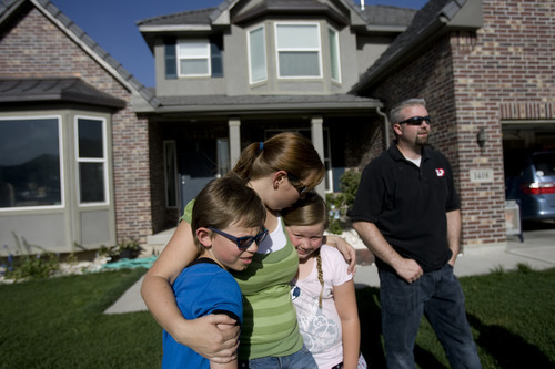 Kim Raff | The Salt Lake Tribune
Jill Derington hugs her children (left) Jacob and Amara Derington outside their home in the Saratoga Springs subdivision in Saratoga Springs, Utah on June 23, 2012. The Derington's evacuated from their home due to the Dump Wildfire in Saratoga Springs-Eagle Mountain area but were able to return.