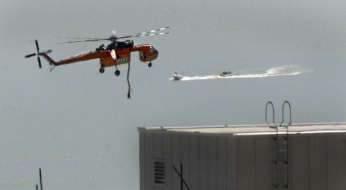 Scott Sommerdorf  |  The Salt Lake Tribune             
A fire-fighting helicopter drops to get a new load of water from Utah Lake in order to fight The Dump Fire near Saratoga Springs and Eagle Mountain, Saturday, June 23, 2012.