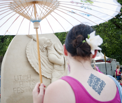 Michael Mangum  |  Special to the Tribune

Visitors admire the sand sculpture of Ted Seibert at the Utah Arts Festival in downtown Salt Lake City on Sunday, June 24, 2012.