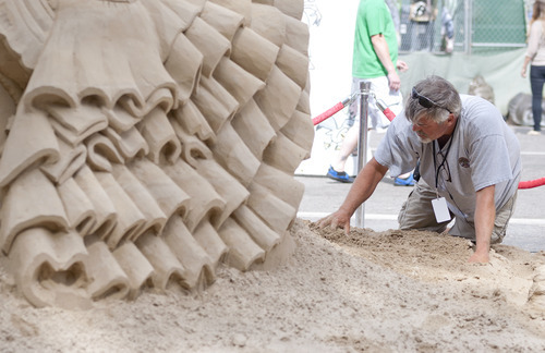 Michael Mangum  |  Special to the Tribune

Ted Seibert puts the finishing touches on his sand sculpture of a flamenco dancer at the Utah Arts Festival in downtown Salt Lake City on Sunday, June 24, 2012.