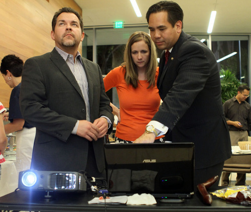 AG candidate, Sean Reyes (right), Saysha Reyes (wife) and Michael Deaver (left) look at the election results just before conceding to John Swallow on election night.  June 26, 2012.  (Michael Brandy, Special to the Tribune).