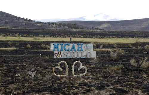 Al Hartmann  |  The Salt Lake Tribune  
Love note on fence is the only color along a burned out area along U.S. Highway 89 near Indianola.  The area burned Sunday in the Wood Hollow fire.