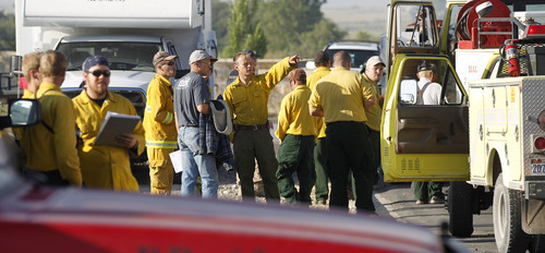 Al Hartmann  |  The Salt Lake Tribune  
Wildland firefighters from multiple agencies gather at the Moroni Elementary School in Moroni Monday morning June 25 to organize and equip themsleves before going out to fight the Wood Hollow fire.