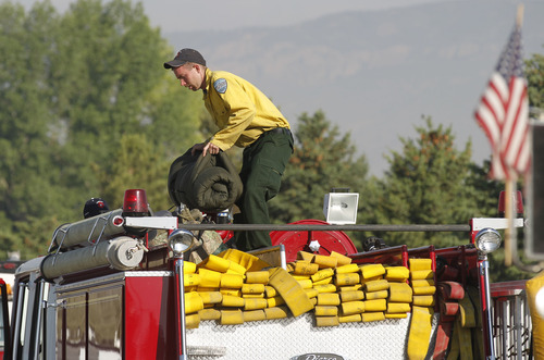 Al Hartmann  |  The Salt Lake Tribune  
Firefighter loads bedroll onto fire truck at the Moroni Elementary School in Moroni Monday morning June 25.  
Wildland firefighters from multiple agencies gathered there to Elementary S to organize and equip themsleves before going out to fight the Wood Hollow fire.