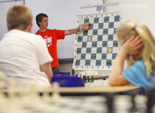 Lennie Mahler  |  The Salt Lake Tribune
Kayden Troff, 14, instructs young chess players how to keep pieces coordinated to block opponents' moves during a lesson at the McGillis School on Monday, June 25, 2012. Troff was selected for the 