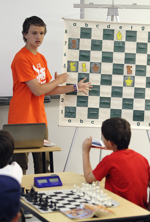 Lennie Mahler  |  The Salt Lake Tribune
Kayden Troff, 14, instructs young chess players on how to keep pieces coordinated to block opponents' moves during a lesson at the McGillis School on Monday, June 25, 2012. Troff was selected for the 