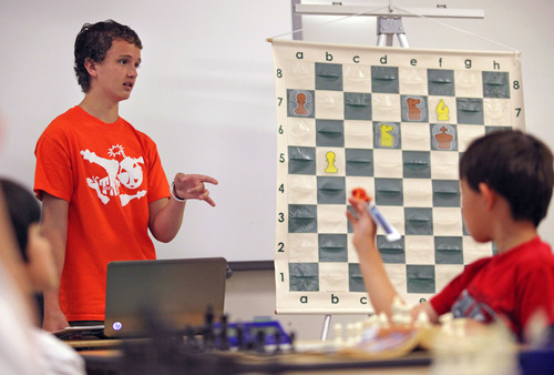 Lennie Mahler  |  The Salt Lake Tribune
Kayden Troff, 14, instructs young chess players on how to keep pieces coordinated to block opponents' moves during a lesson at the McGillis School on Monday, June 25, 2012. Troff was selected for the 