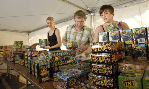 Paul Fraughton | Salt Lake Tribune
Heather Smith, left, Christopher Howard, and Ashley Porter stock the fireworks stand at 1700 South and 900East in Salt Lake City. The three University of Utah students are selling fireworks as a fundraiser for the university's music department.
 Monday, June 25, 2012