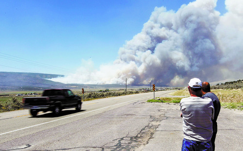 Al Hartmann  |  The Salt Lake Tribune  
Folks watch smoke plume from the Wood Hollow fire as it reaches U.S Highway 89 north of Indianola on Tuesday, June 26, 2012, about 2:15 p.m. The fire was reinvigorated from high winds and the highway closed a few minutes later.