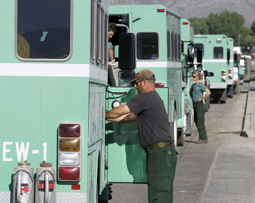 Al Hartmann  |  The Salt Lake Tribune  
U.S. Forest Service Boise Hotshot crews ready their trucks at the fire command center in Moroni Tuesday morning June 26 before heading out to fight the Wood Hollow fire.