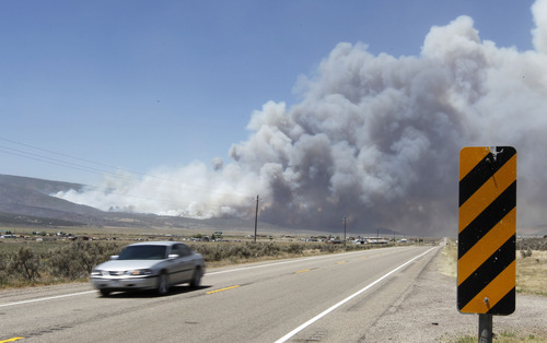 Al Hartmann  |  The Salt Lake Tribune  
Car heads south on U.S HIghway 89  on Tuesday, June 26, 2012, about 2:15 p.m., away from the Wood Hollow fire smoke plume near Indianola. The fire was reinvigorated from high winds and the highway closed a few minutes later.