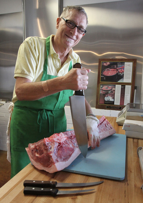 Francisco Kjolseth  |  The Salt Lake Tribune
Frody Volgger is the man behind Caputo's market and deli's new butcher shop inside its downtown store. This long-time Utah chef recently battled colon cancer and had to close his restaurant, Vienna Bistro. But now he is back, butchering whole pigs and lambs and making fresh sausages, smoked hams and, his specialty, speck (smoked proscuitto).