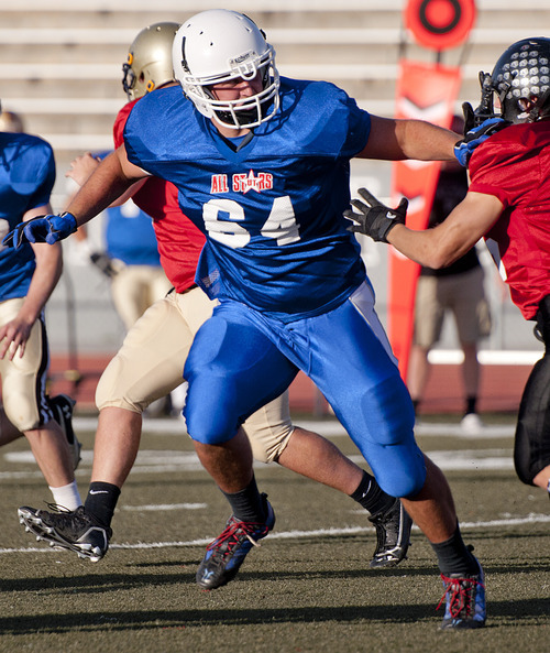 Michael Mangum  |  Special to the Tribune
Fremont defensive lineman Luke Hollingsworth, 64, stiff-arms Alta running back Bryan Engstrom, 26, in pursuit of the ball during the first half of play of the Utah High School Coaches Association 4A/5A all-star football game at Alta High School.