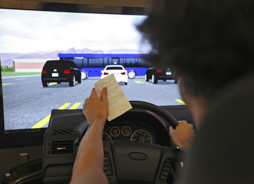 Lennie Mahler  |  The Salt Lake Tribune
Liam Koester, 17, drives a simulator while reading from a note at the Utah Traffic Lab on the University of Utah campus. The simulator tracks reaction times as well as how the driver interacts with other cars on the road individually.