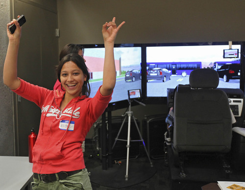 Lennie Mahler  |  The Salt Lake Tribune
Aliya Khan celebrates after finishing a driving simulation at the Utah Traffic Lab at the University of Utah. The simulator is designed to place the driver in dangerous situations where reaction time is crucial. The simulator tracks drivers' times, crashes and the way the driver interacts with other cars on the road.