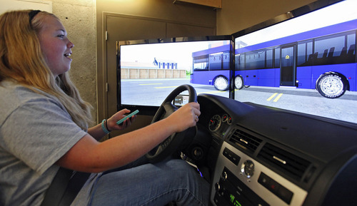 Lennie Mahler  |  The Salt Lake Tribune
Michelle Rechis, 15, reacts to an unexpected bus while texting and driving in a simulator at the Utah Traffic Lab on the University of Utah campus. The simulator is designed to place the driver in dangerous situations where reaction time is crucial. The simulator tracks drivers' times, crashes and the way the driver interacts with other cars on the road.
