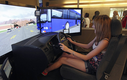 Lennie Mahler  |  The Salt Lake Tribune
Maddy McKenzie, 15, reacts to an unexpected bus while driving a simulator at the Utah Traffic Lab on the University of Utah campus. The simulator is designed to place the driver in dangerous situations where reaction time is crucial. The simulator tracks drivers' times, crashes and the way the driver interacts with other cars on the road.