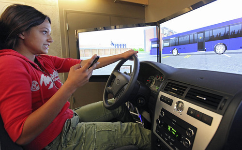 Lennie Mahler  |  The Salt Lake Tribune
Aliya Khan, 16, reacts to an unexpected bus while texting and driving in a simulator at the Utah Traffic Lab on the University of Utah campus. The simulator is designed to place the driver in dangerous situations where reaction time is crucial. The simulator tracks drivers' times, crashes and the way the driver interacts with other cars on the road.