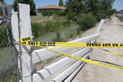 Lennie Mahler  |  The Salt Lake Tribune
A West Jordan canal flows downstream from where the body of a 6-year-old girl was found Tuesday, June 26, 2012.