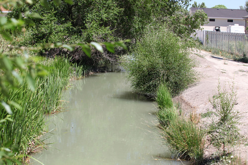 Lennie Mahler  |  The Salt Lake Tribune
A West Jordan canal flows downstream from where the body of a 6-year-old girl was found Tuesday, June 26, 2012.