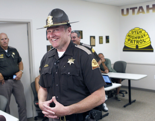Al Hartmann  |  The Salt Lake Tribune  
UHP trooper Alex Williams is honored by the Utah Highway patrol in Ogden on Wednesday, June 27, 2012, for stopping to help with Bob Nicholson and  Jason Navarro in helping  extricate and save the life of Heidi Orosco, whose car was upside down and submerged in water along I-15 at milepost 361. She was unresponsive and under water from her shoulders up. Navarro flagged down Williams' UHP car and provided the knife to him to cut her out of her seatbelt while Nicholson and Navarro helped keep her head above water until emergency crews arrived.